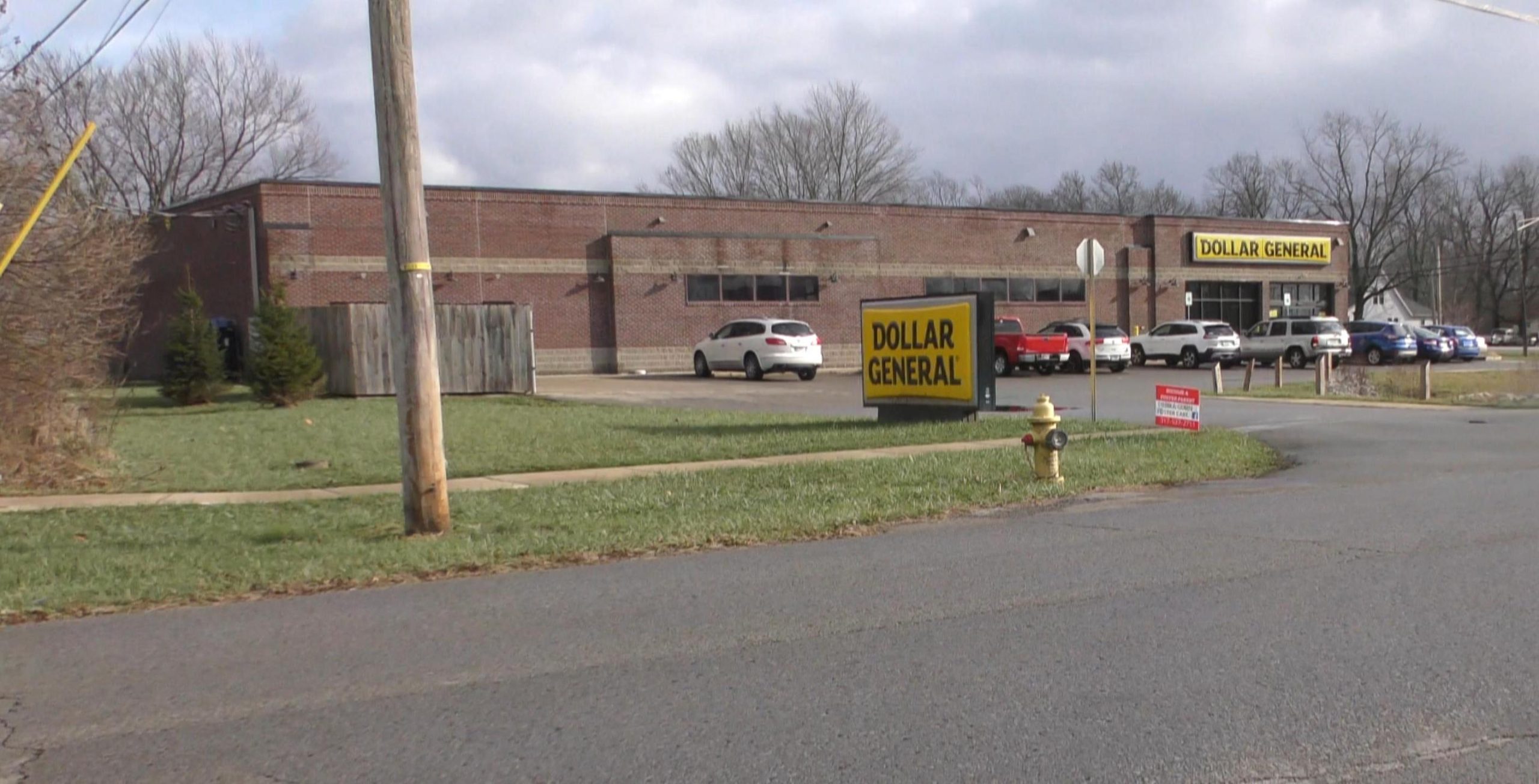 exterior view of Dollar General showing both the street sign and the sign over the door.